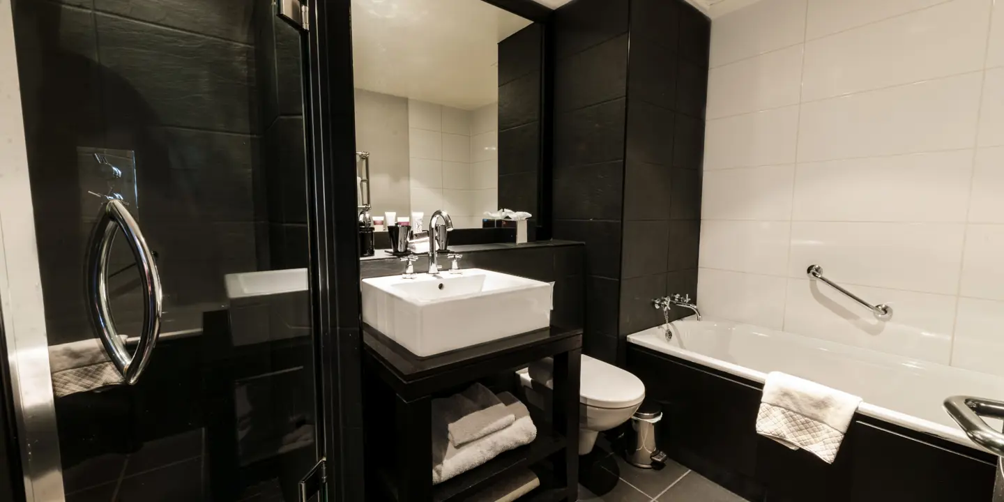 A bathroom featuring a sink, toilet, and bathtub.