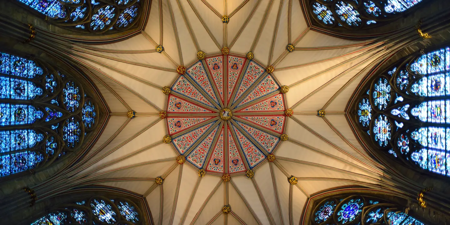 Ceiling of a cathedral featuring exquisite stained glass windows.