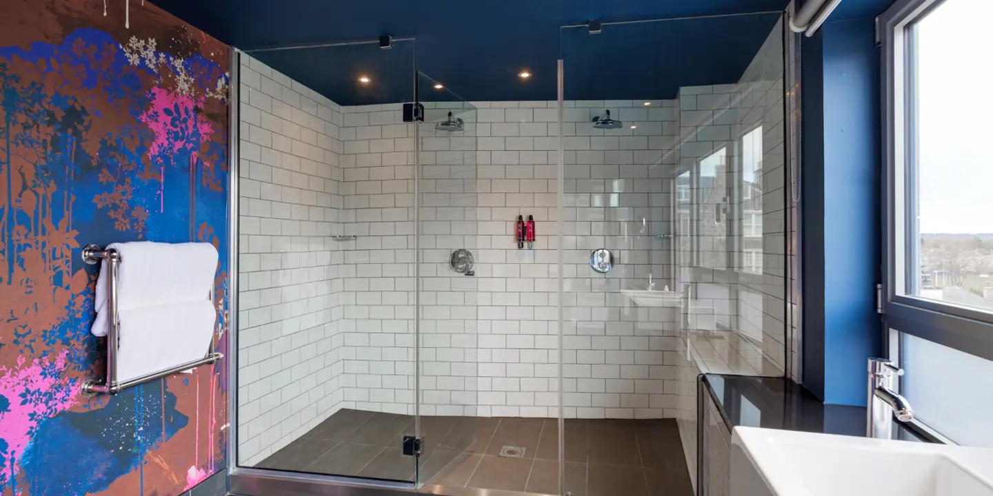 Bathroom with large dual walk in shower and dual sinks. 
