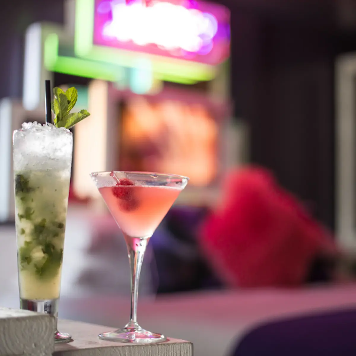 Two cocktails placed on a table.