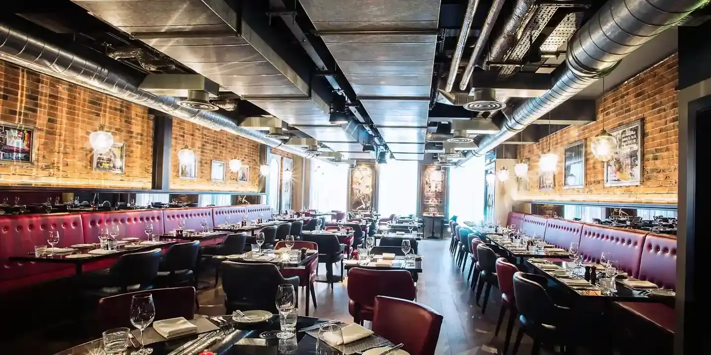 A restaurant featuring tables and red booths.