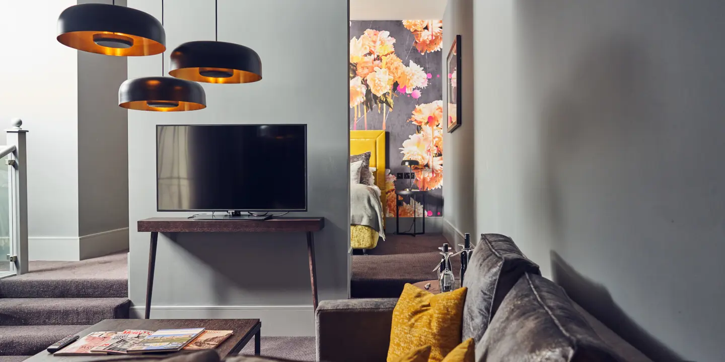 A well-furnished living room featuring a flat-screen TV.