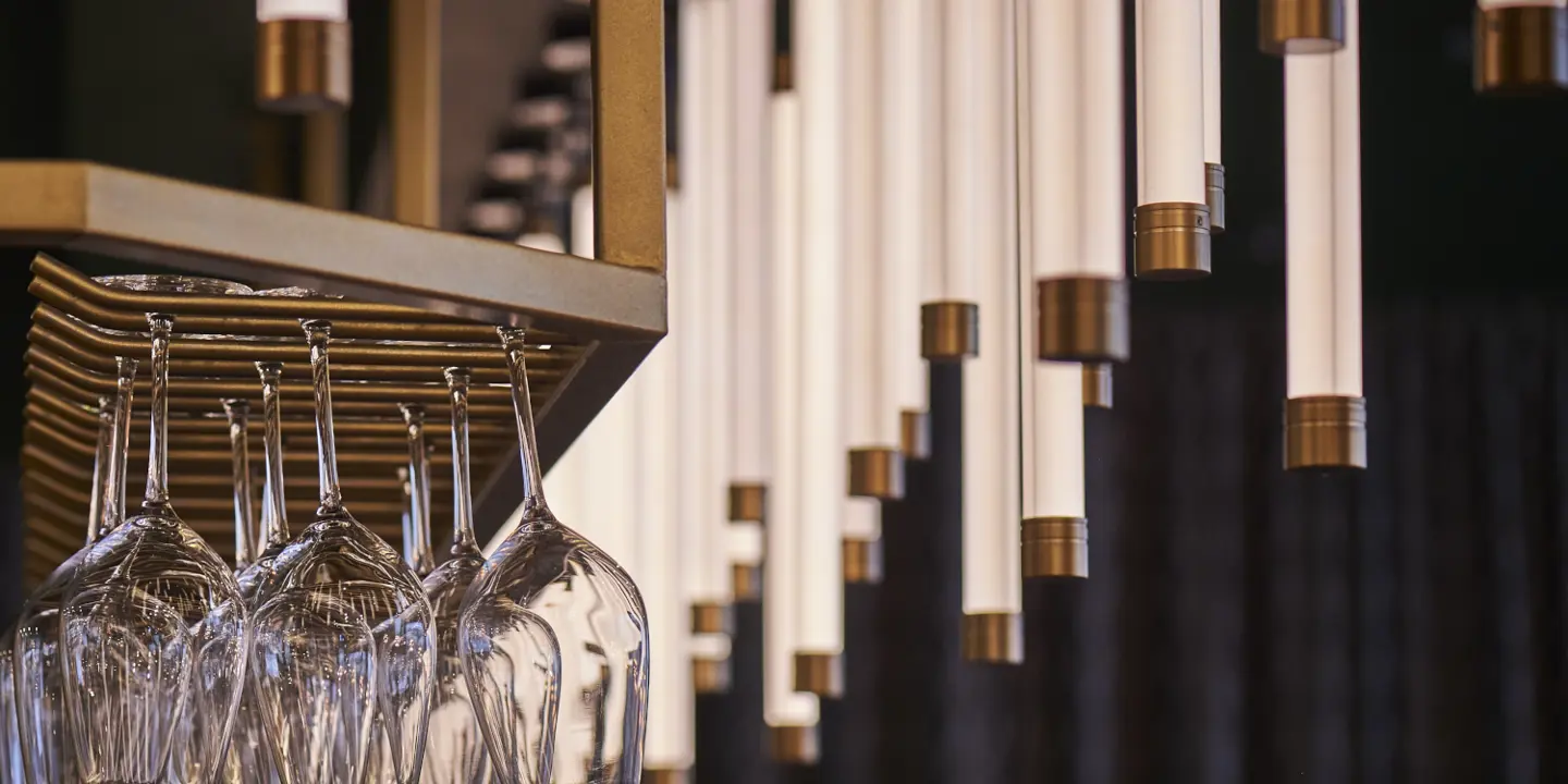 Wine glasses suspended from a rack
