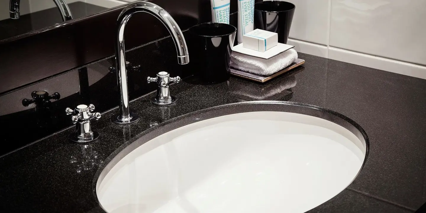 Bathroom sink with sleek black countertop