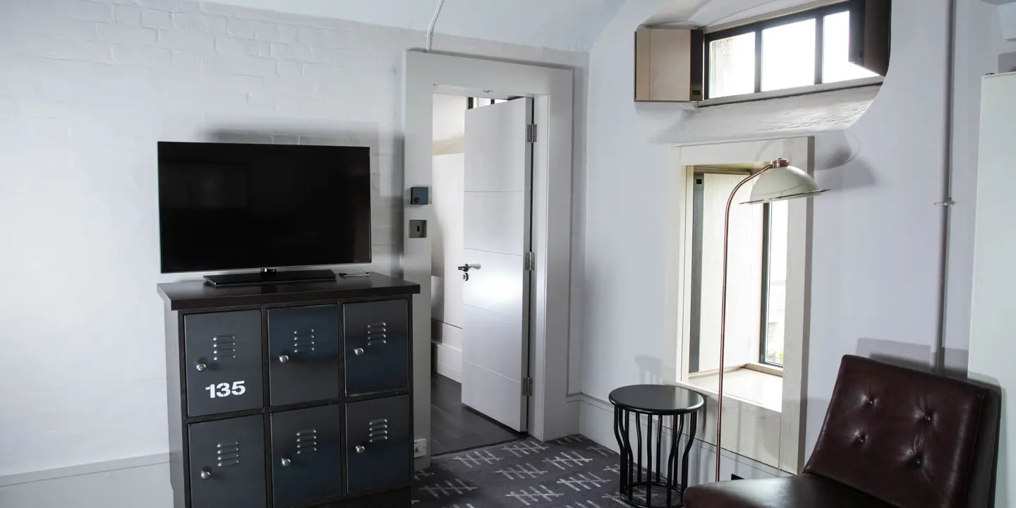 An inviting living room featuring a television and a comfortable chair.