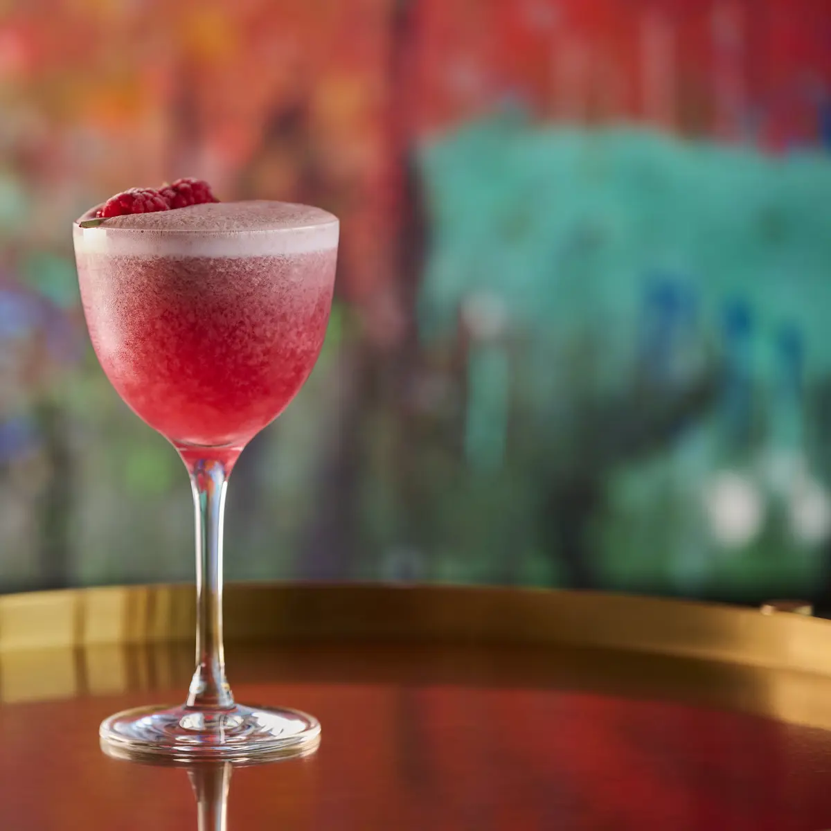 Multiple different cocktail glasses containing different beverages.