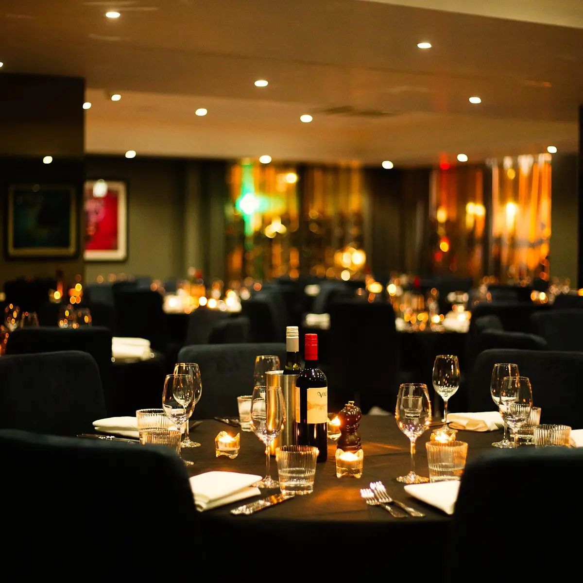 A table displaying wine glasses and bottles of wine.