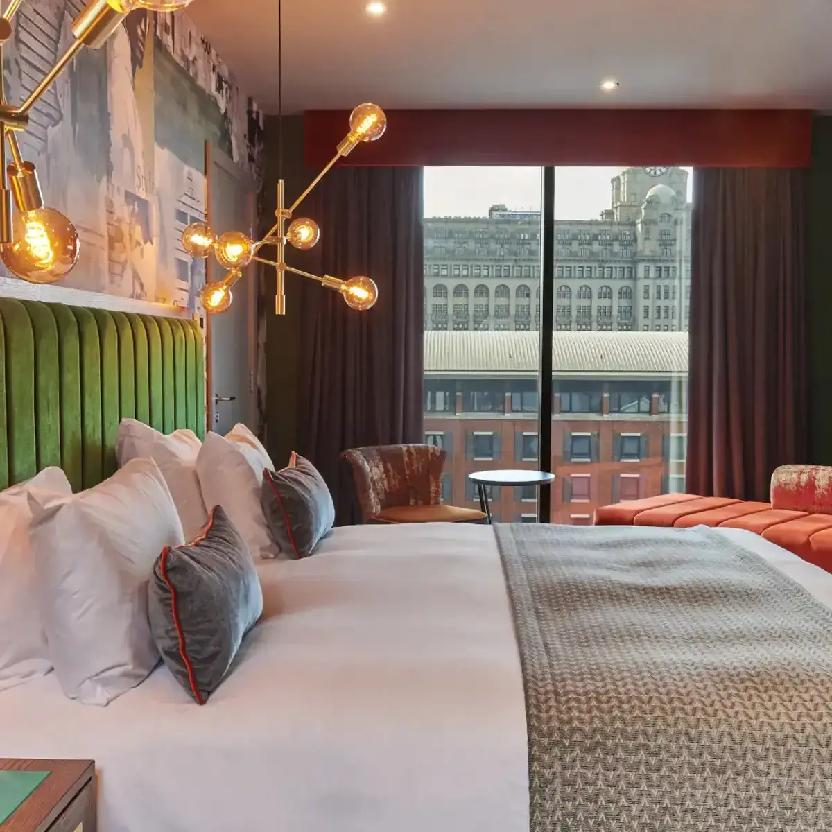 Spacious hotel room featuring a king-sized bed and panoramic city view.