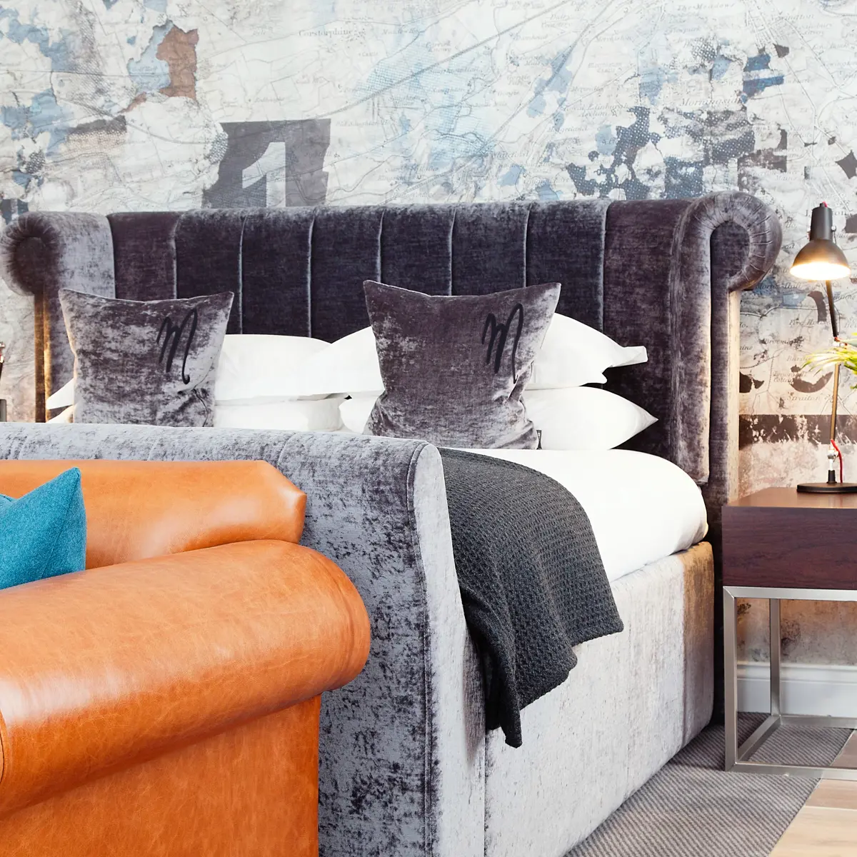 Bedroom featuring a comfortable bed and a stylish couch.