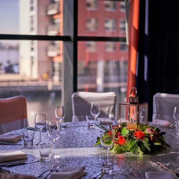 A beautifully arranged table for an elegant dinner, showcasing a breathtaking cityscape view.