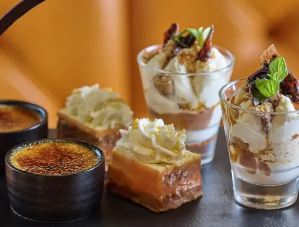 Assortment of pastries and desserts displayed on a table.
