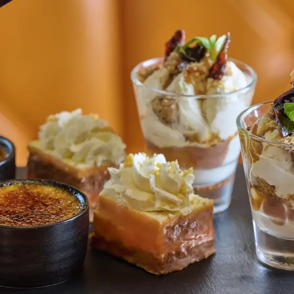 Assortment of pastries and desserts displayed on a table.