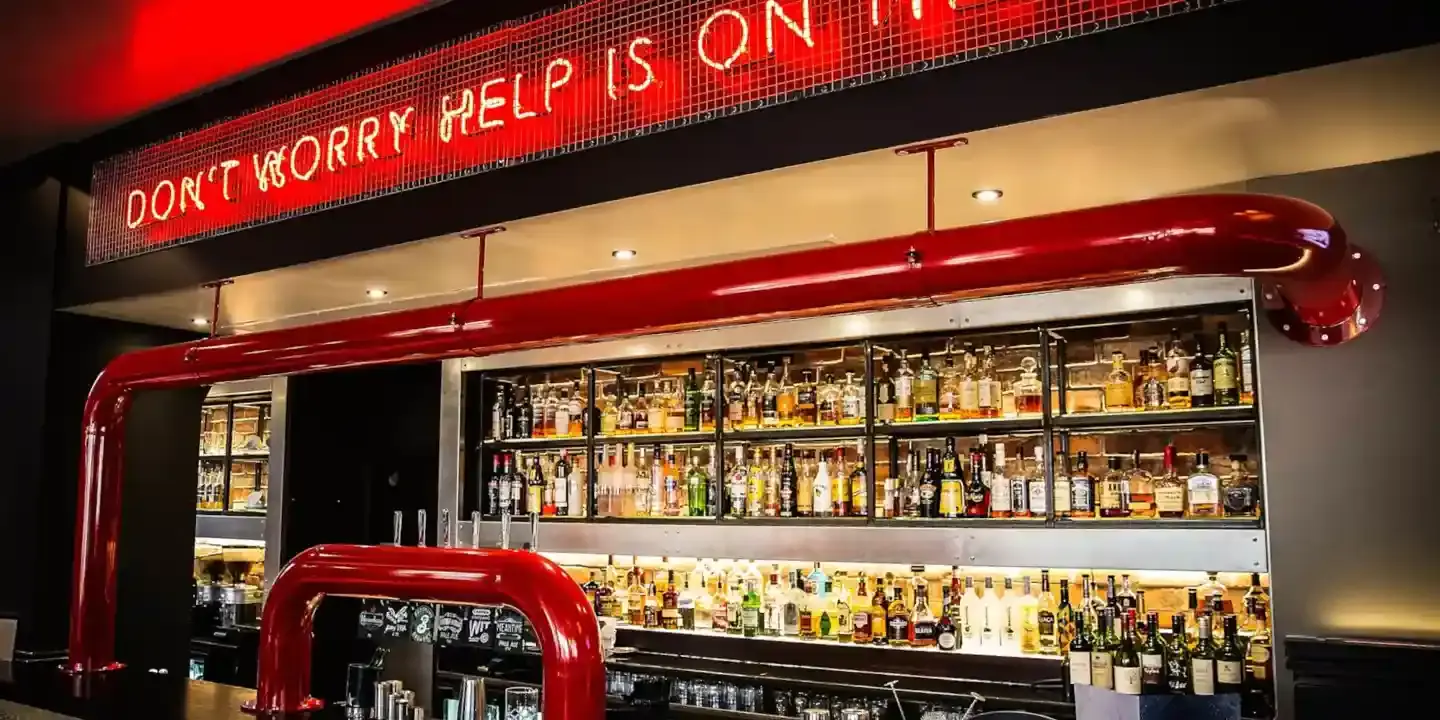 A bar featuring a neon sign.