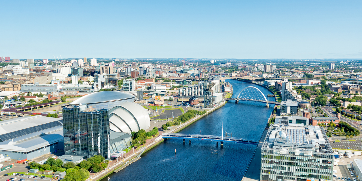 River flowing through a city alongside a bridge.