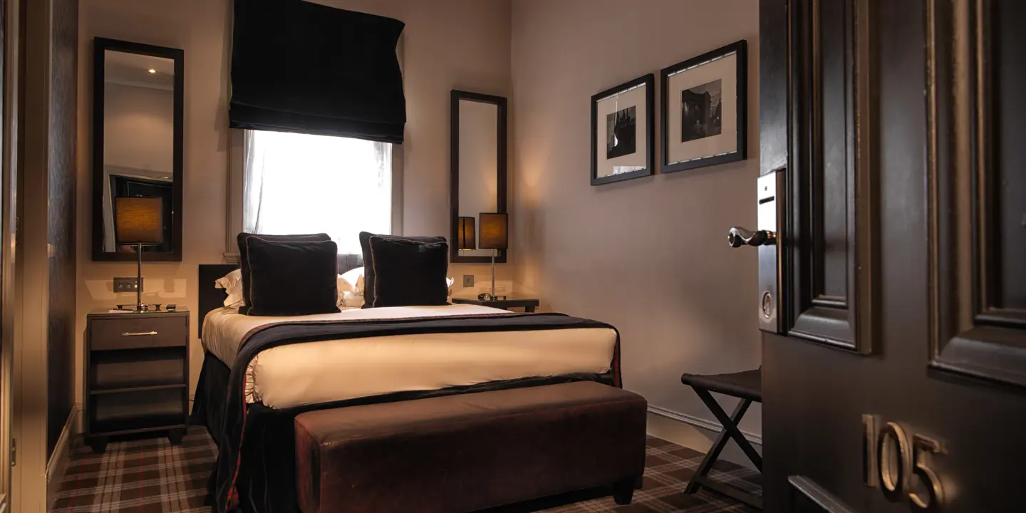 An elegantly furnished bedroom featuring a comfortable bed and a stylish chair.