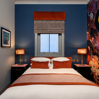 An elegantly furnished bedroom featuring a comfortable bed and a stylish chair.
