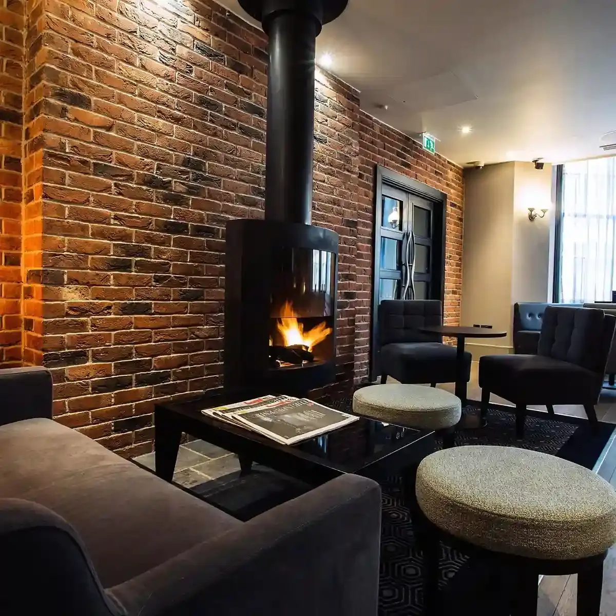 A well-furnished room featuring a cozy fireplace.