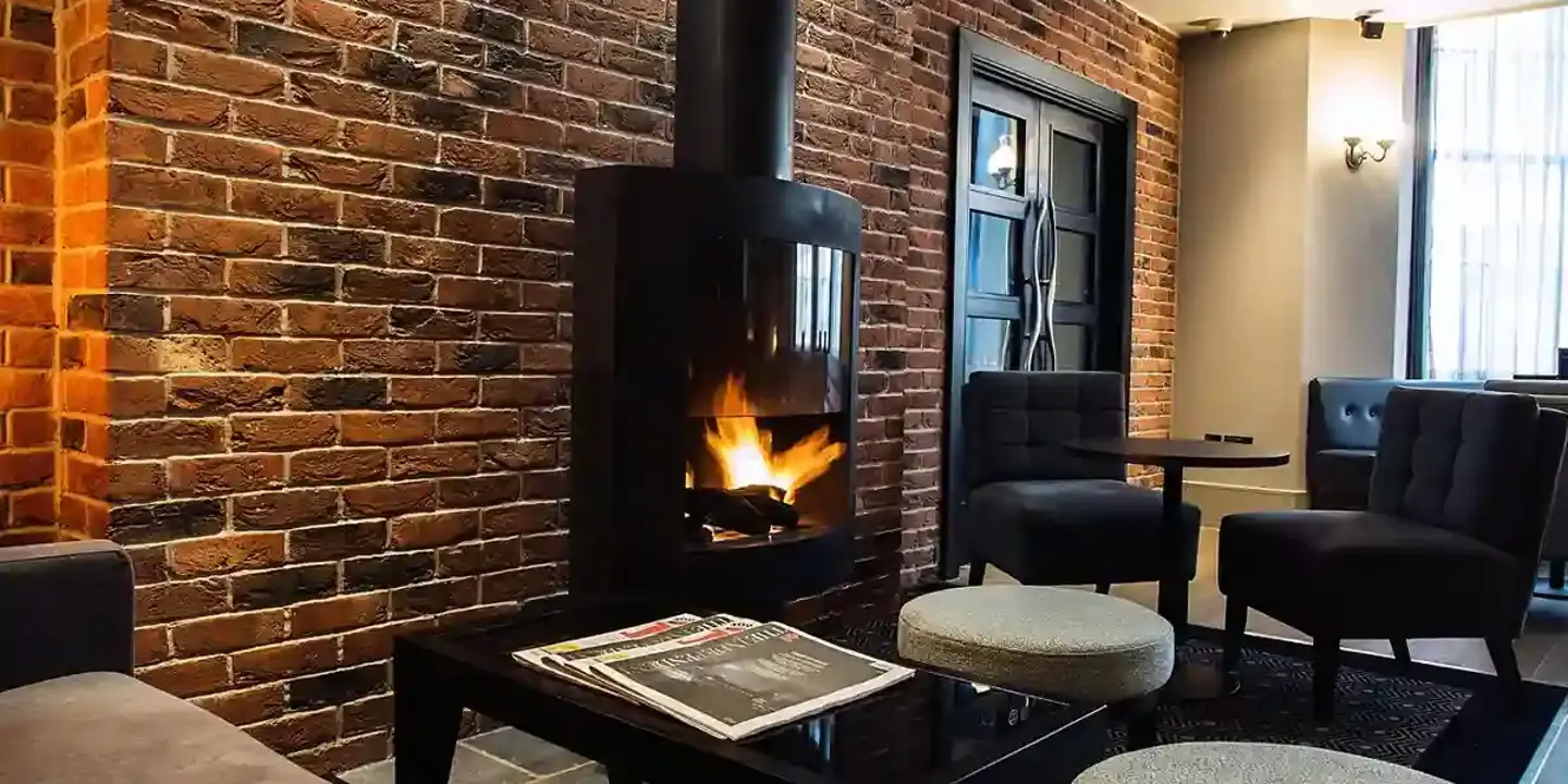 A well-furnished room featuring a cozy fireplace.