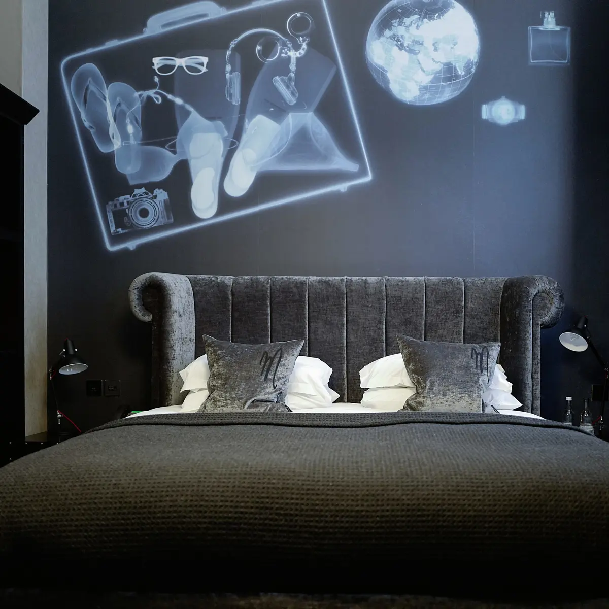 Bed in a room with a black wall.