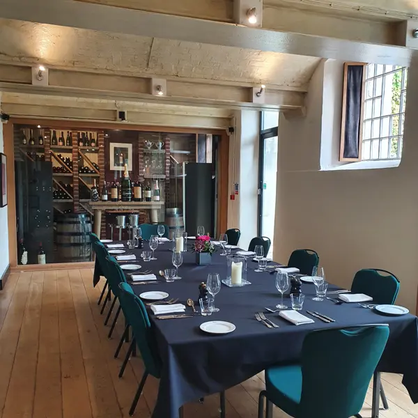 A dining room featuring a lengthy table adorned with blue chairs.