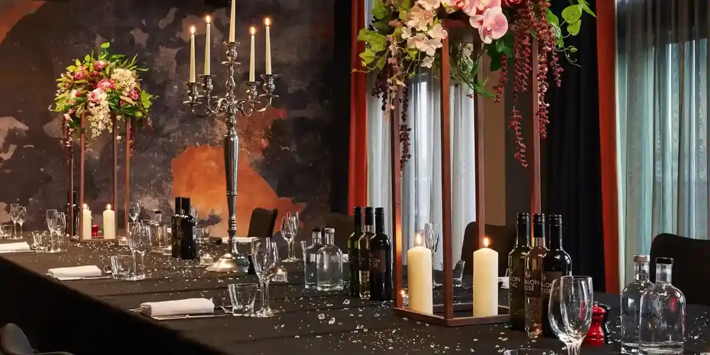 A beautifully arranged table adorned with elegant wine glasses and flickering candles.