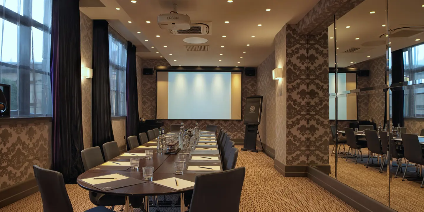 Conference room with projector screen and chairs.