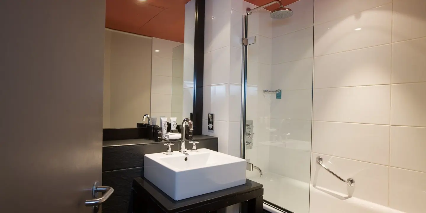 A bathroom featuring a sink and shower.