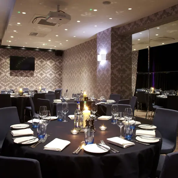 A beautifully arranged table for a formal dinner, adorned with elegant candles.