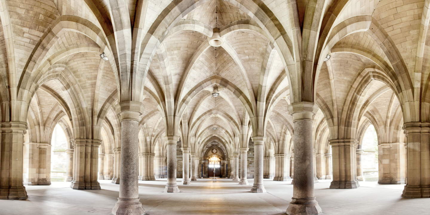 A spacious room adorned with numerous columns and a high ceiling.