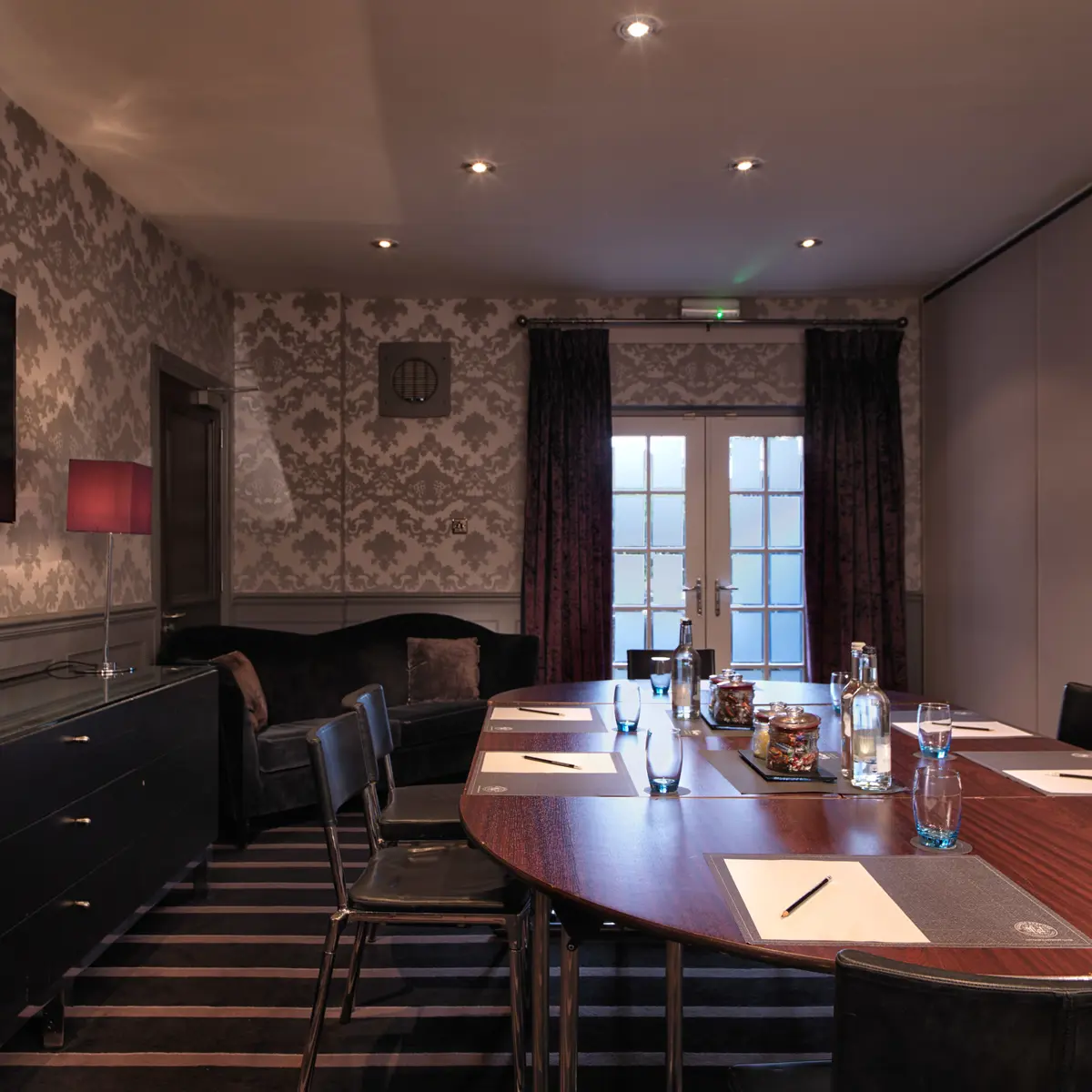 Conference room featuring a spacious table and chairs.