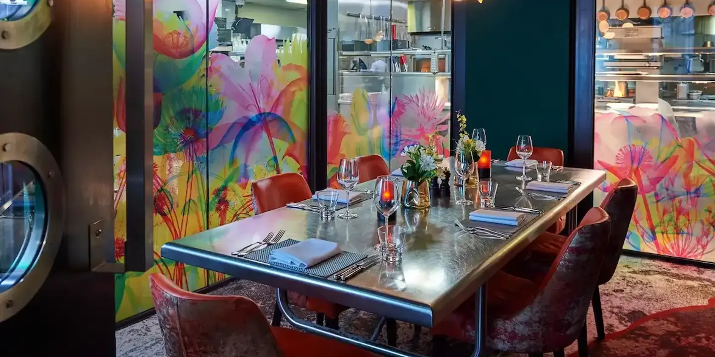 A table adorned with wine glasses and neatly arranged place settings.