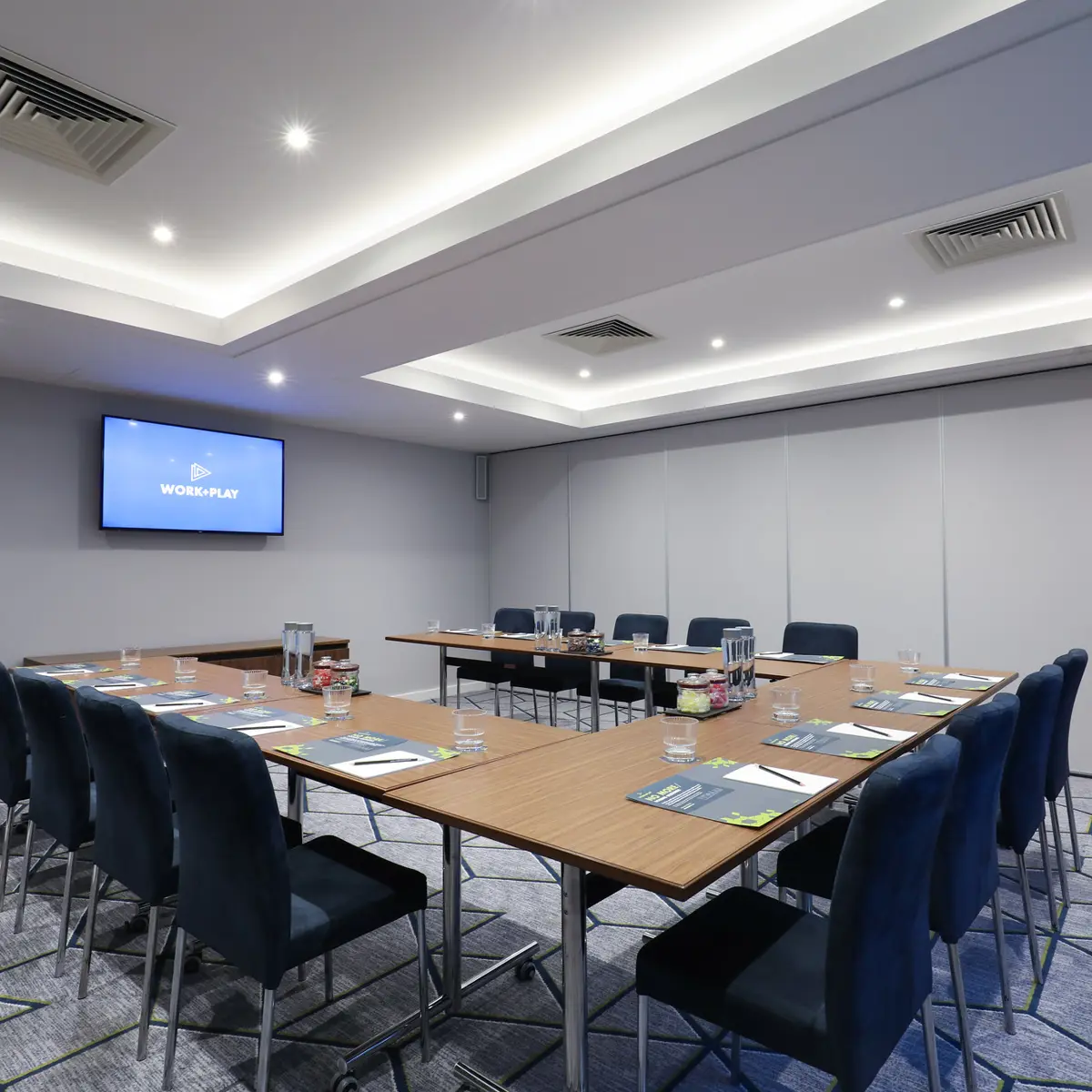 Conference room featuring a spacious table and chairs.