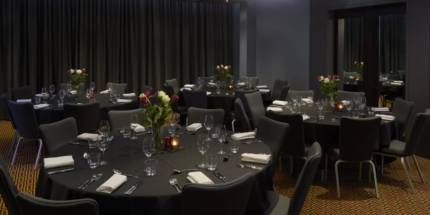 A beautifully arranged dining table with elegantly set place settings.