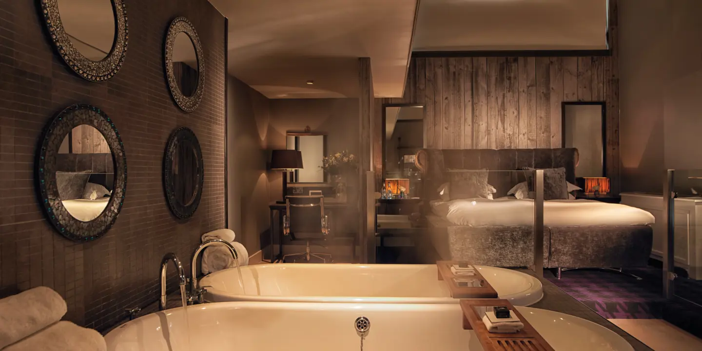 A bathroom featuring a bathtub and a wall-mounted mirror.