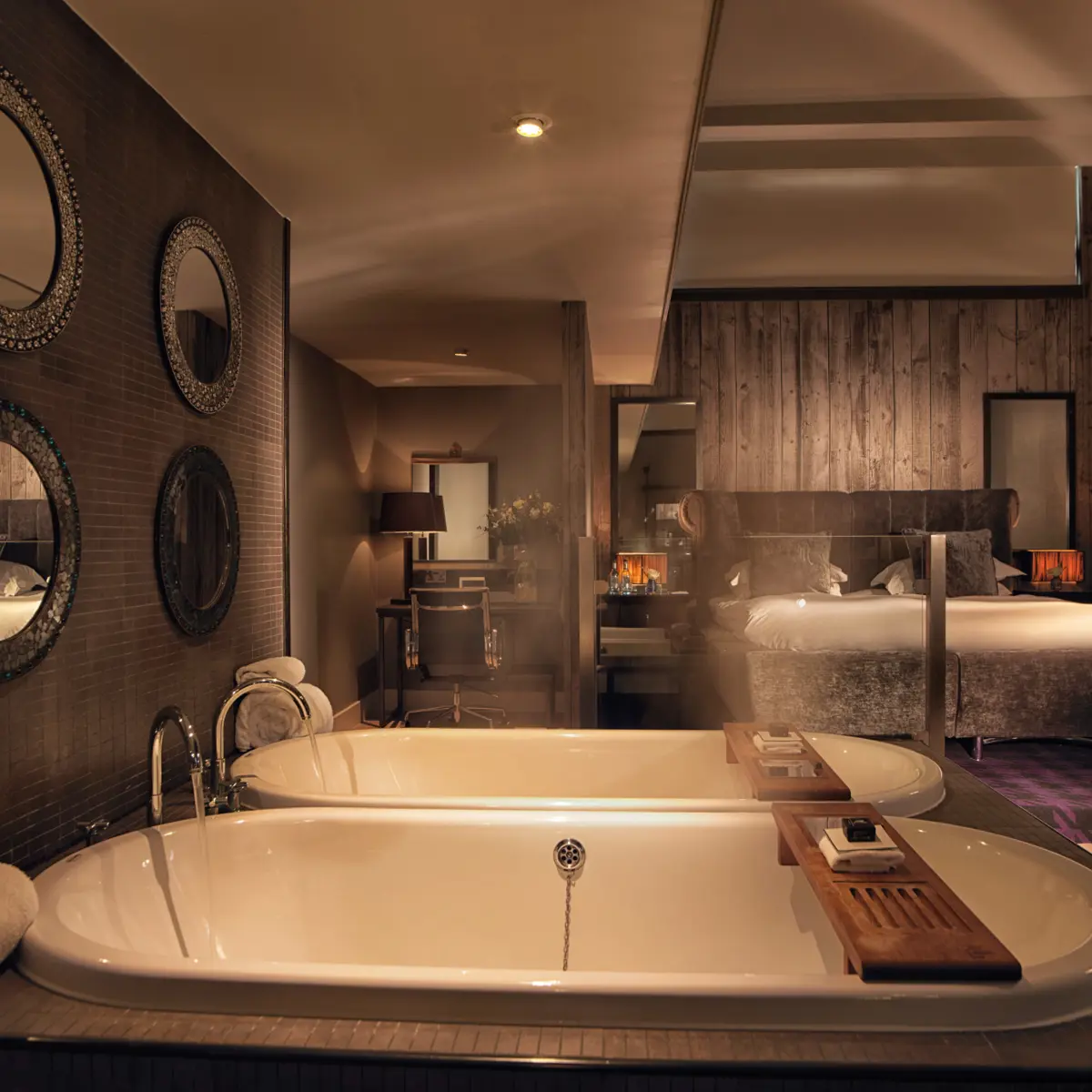 A bathroom featuring a bathtub and a wall-mounted mirror.