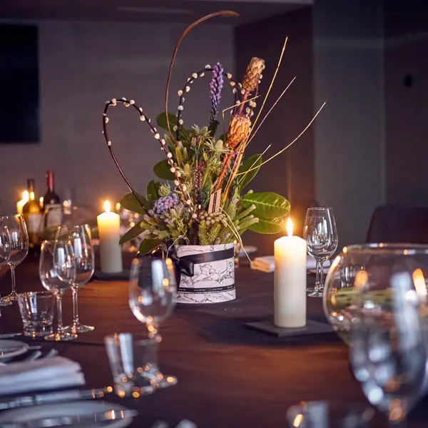 A beautifully arranged table adorned with elegant wine glasses and gleaming silverware.