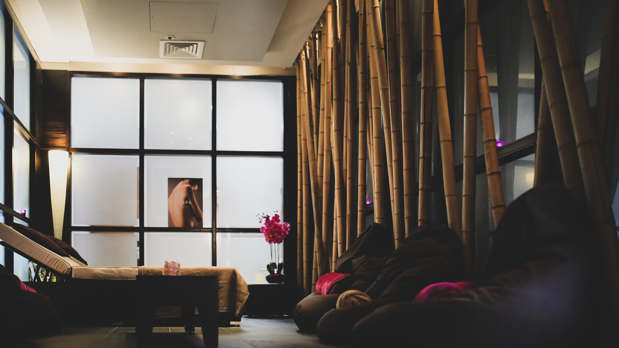 Spa Birmingham treatment room with beanbags, recliner seats, and bamboo feature wall.