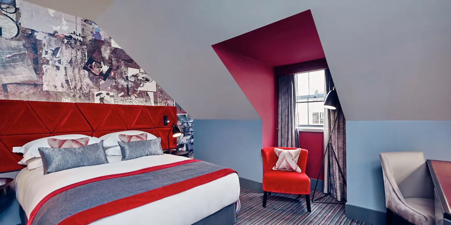 Bedroom featuring a red headboard and chair.