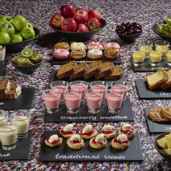 Tray of food displayed on a table in front of a captivating mural.