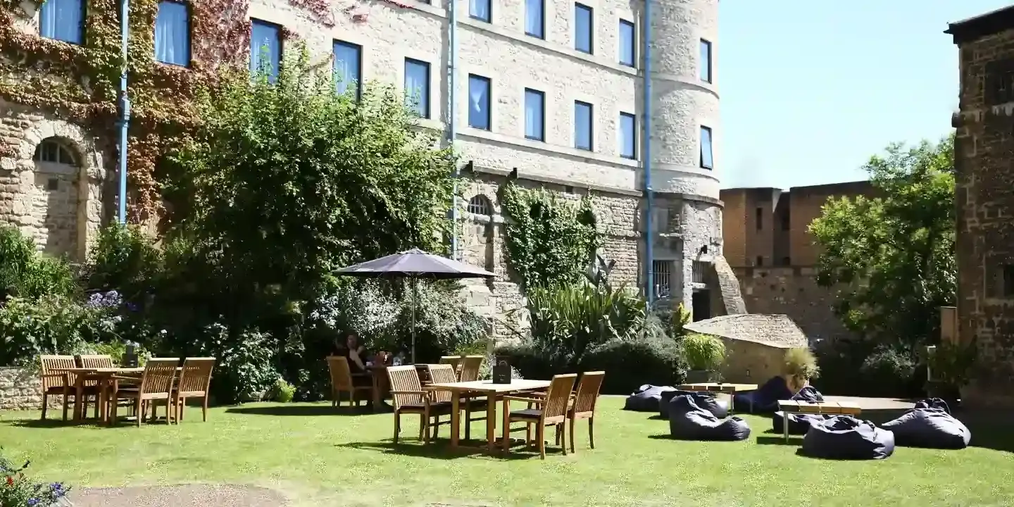 Tables and chairs arranged in a courtyard.