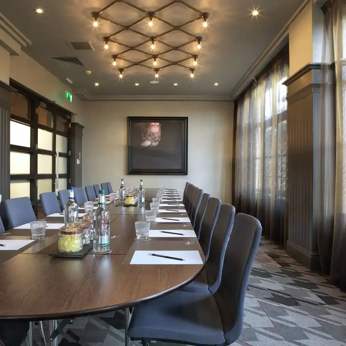 Conference room featuring a spacious table and chairs.
