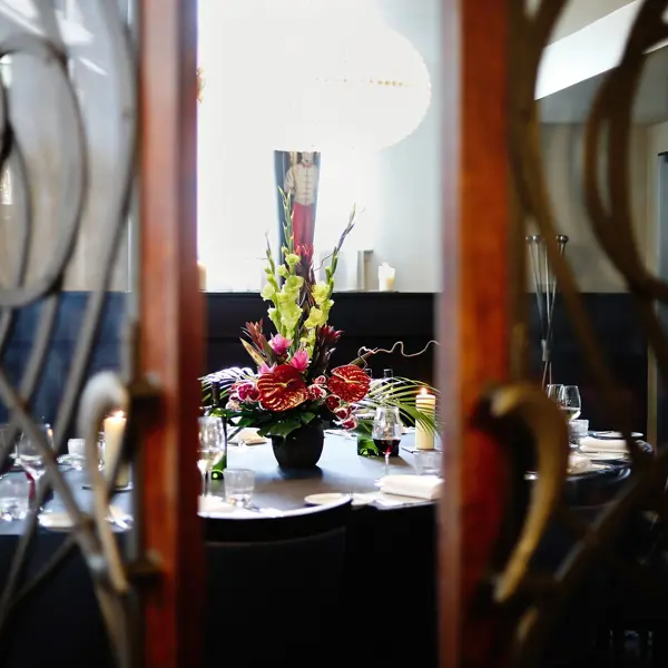 A dining table adorned with a tastefully arranged vase of flowers.