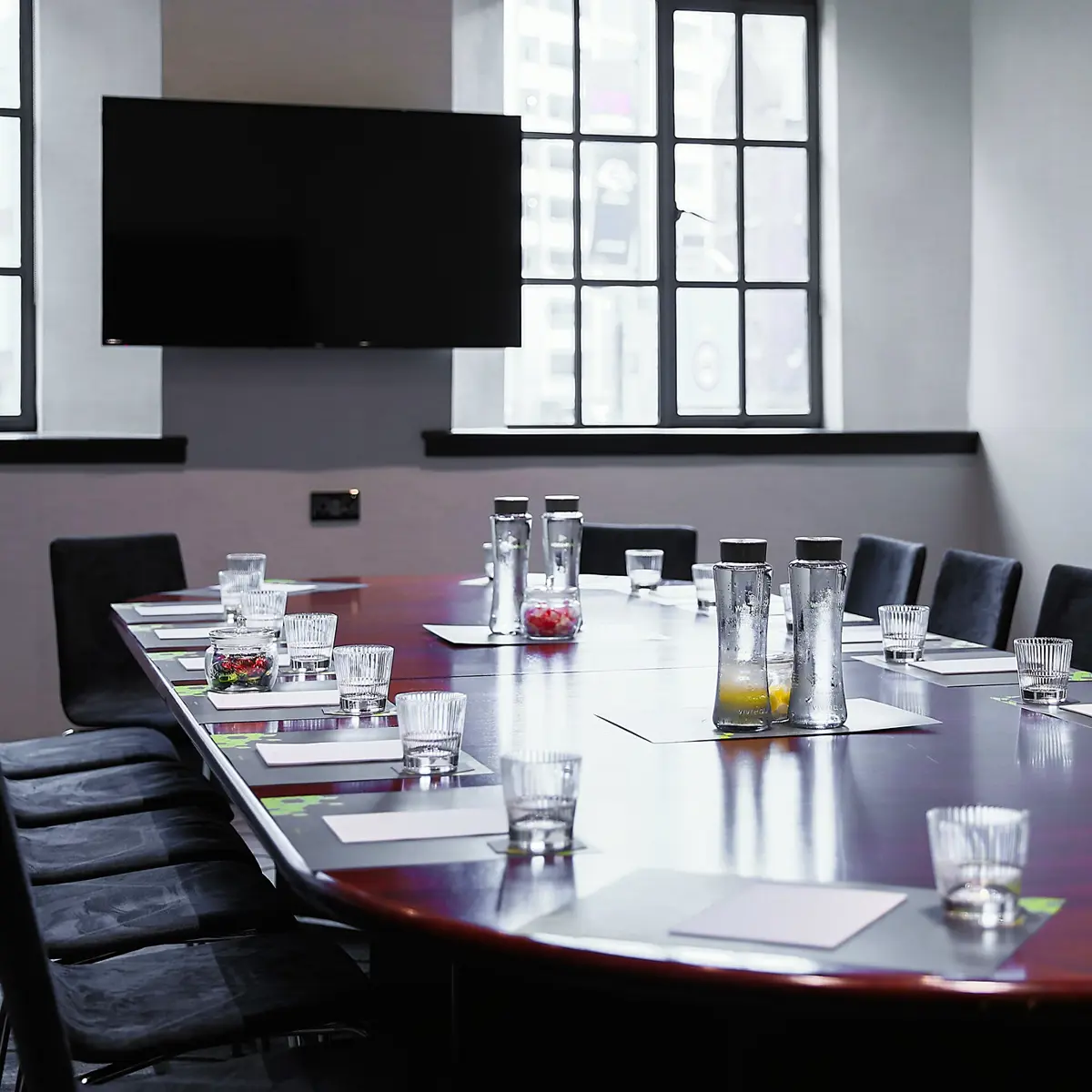 Conference room featuring a spacious table and chairs.