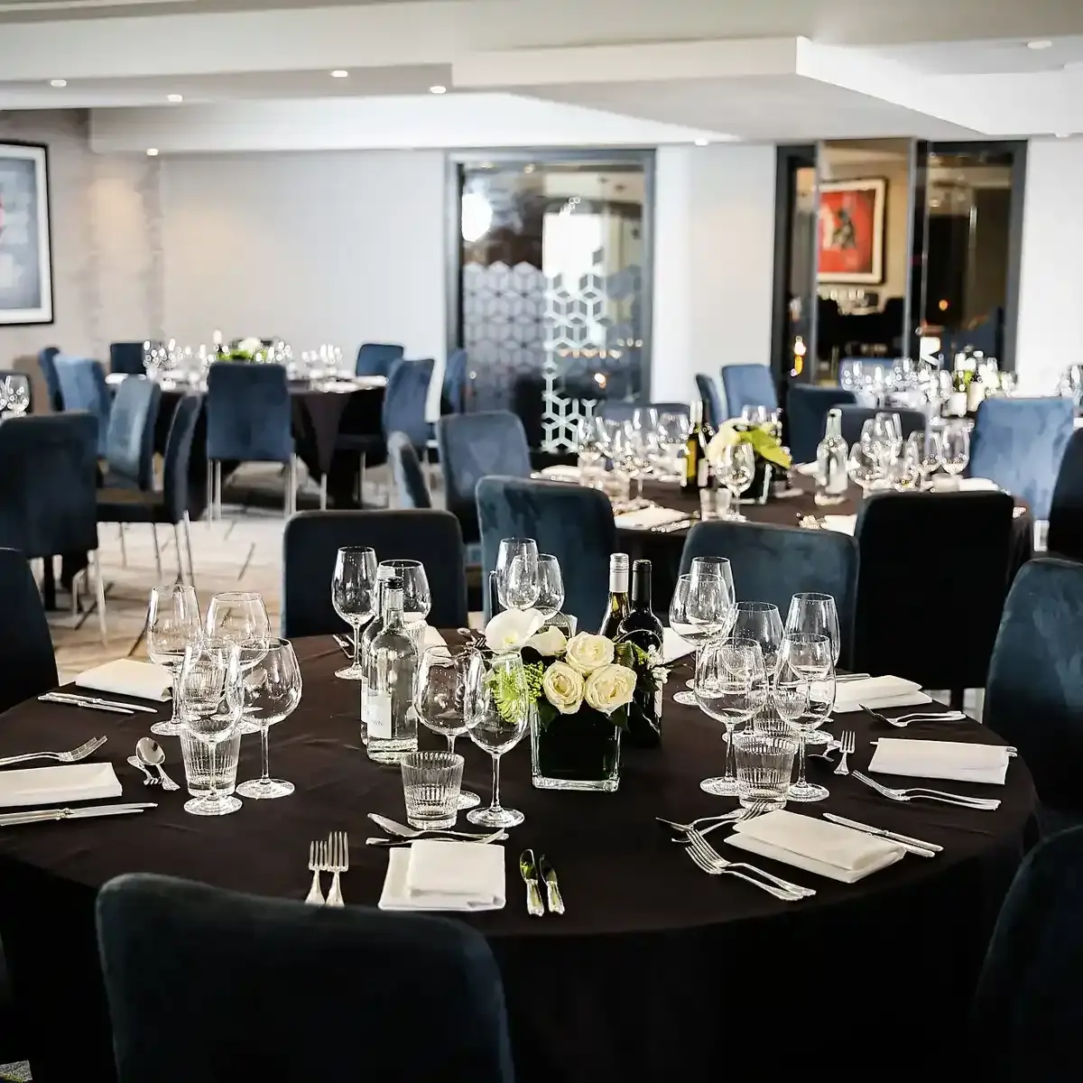 Malmaison Birmingham Private Dining Table set for a formal dinner with blue chairs.