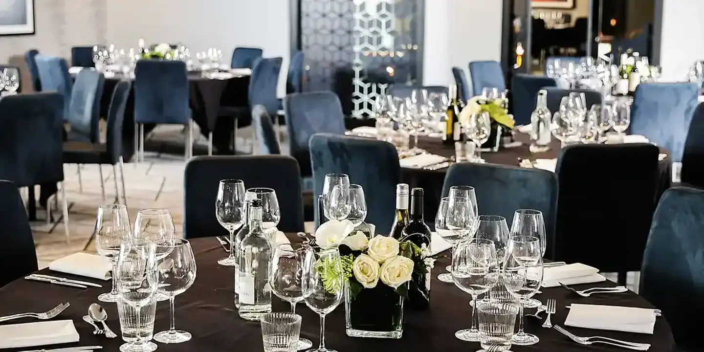 Malmaison Birmingham Private Dining Table set for a formal dinner with blue chairs.
