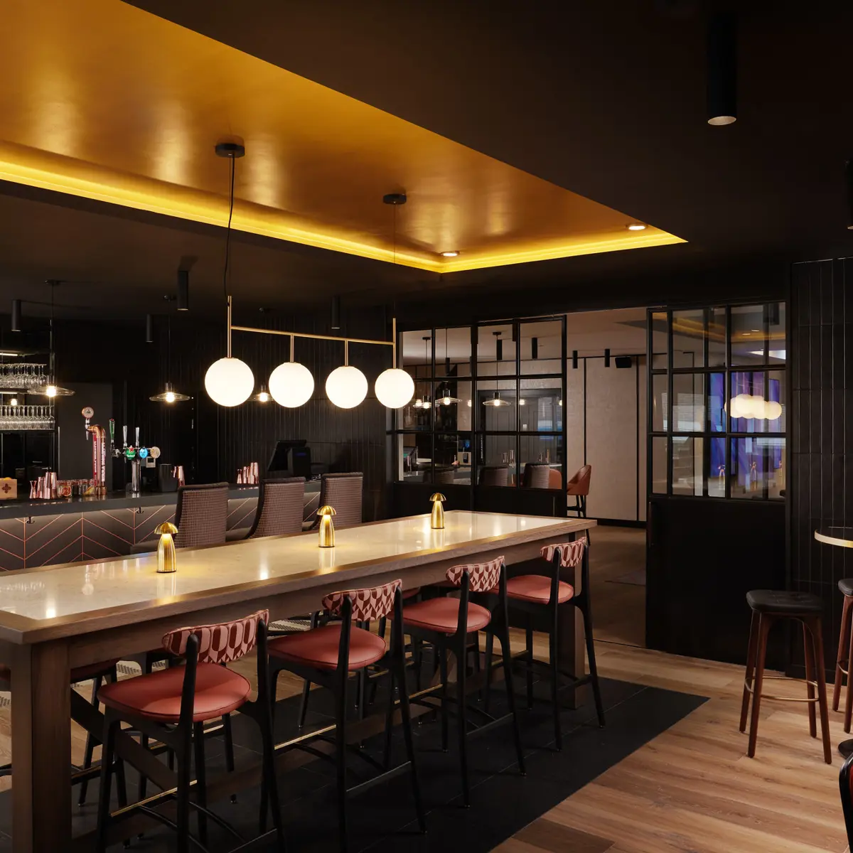 A spacious bar with numerous stools and tables.