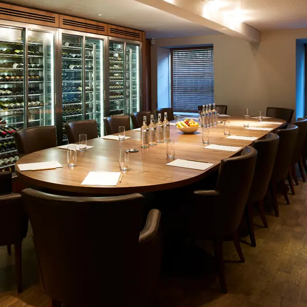 A table adorned with an assortment of glass water bottles and elegant glasses.