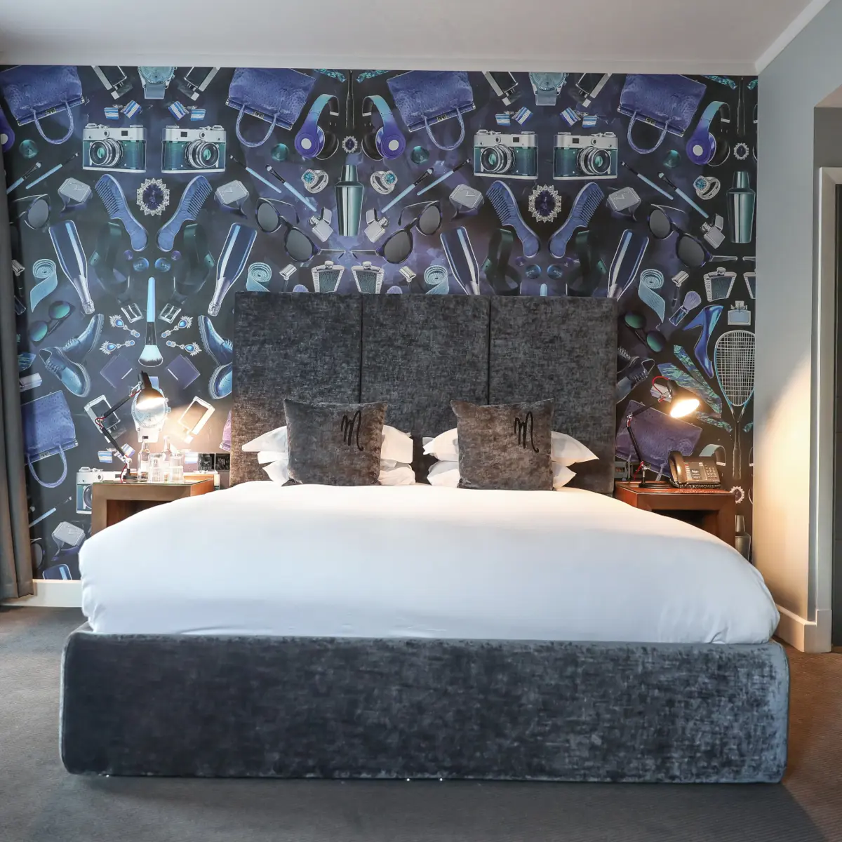 Spacious bedroom featuring a king-sized bed and an elegant wall painting.