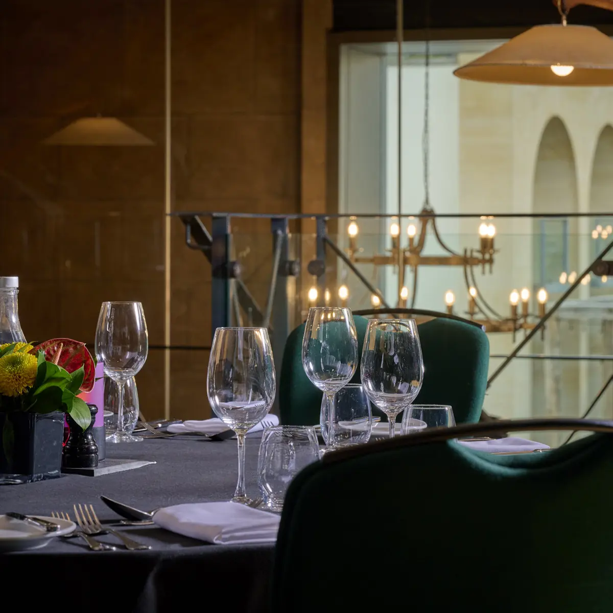 A table adorned with a vase filled with flowers and accompanied by flickering candles.