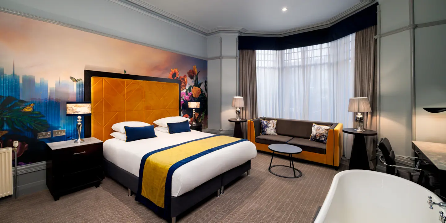 Bedroom with large bed and armchair.